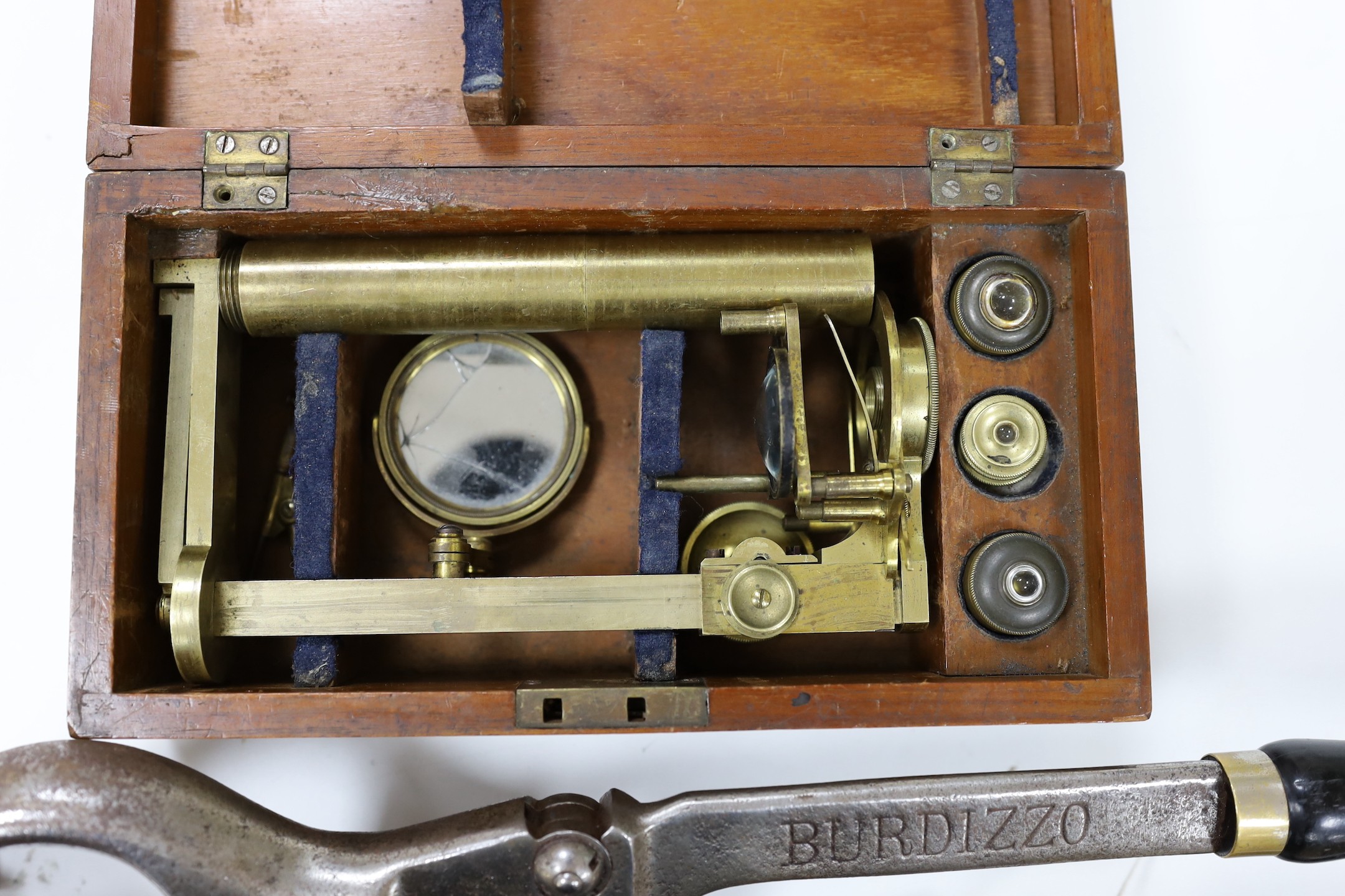 A mahogany cased microscope and a pair of Burdizzo tail dockers, 40cms long